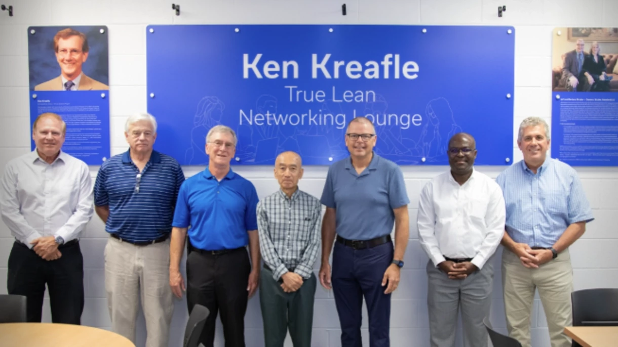 A group picture of Lean Systems Program leadership with Dean Buchheit and Jeff Stryker in front of Ken's dedication plaques